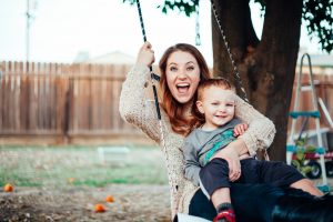 Young mother and child on a swing